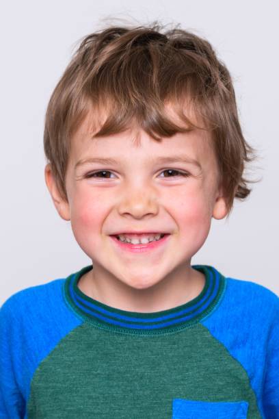 istock Smiling little boy looking at the camera on white background 1263465232