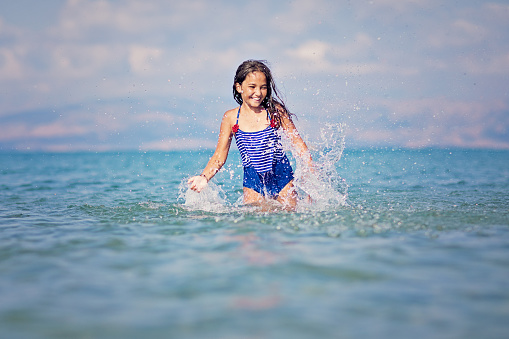 Happy girl is enjoying the ocean