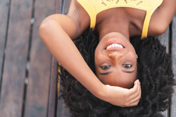 istock Afro woman lying on the floor looking at camera 1263467986
