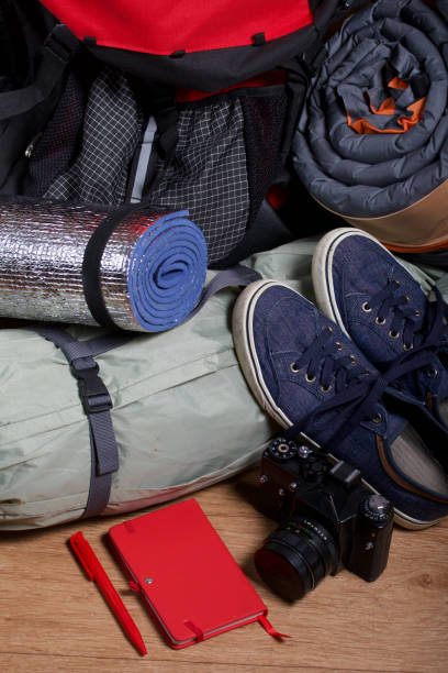 istock Tourist equipment. Self-inflating rugs, tent and camera with a notebook. 1263468942
