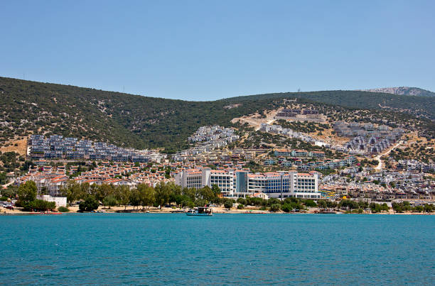 In the middle of the touristic season in Turkish resort Didyma ( saplı ada didim altınkum) the beach is not crowded cos of covid 19. People resting and swimming near the seaside.