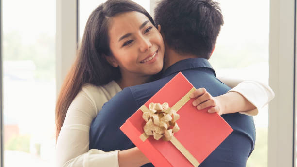 istock Romantic couple giving gift to lover at restaurant 1263471764