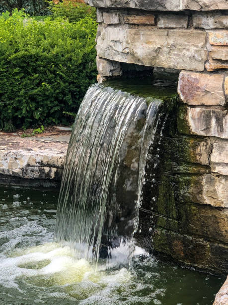 istock Small man-made waterfall in botanical garden 1263475293