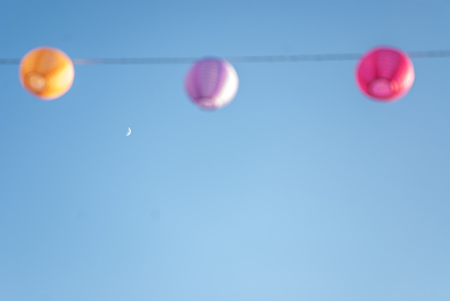 Colorful Light Lampions Hanging over Blue Sky