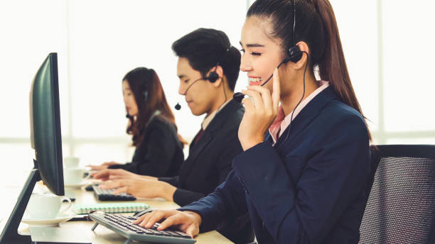 istock Business people wearing headset working in office 1263476268