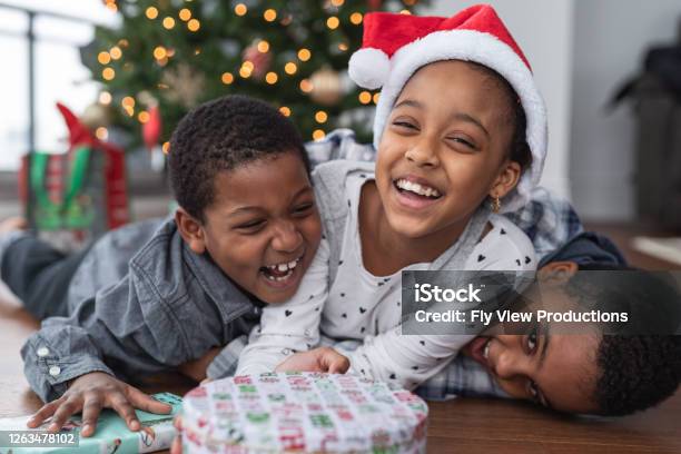 Sibling Fun On Christmas Day Stock Photo - Download Image Now - Child, Christmas, Christmas Present
