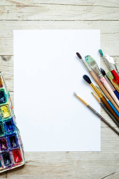 istock Artist paint brushes on the wooden background 1263478183