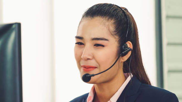 istock Business people wearing headset working in office 1263479302