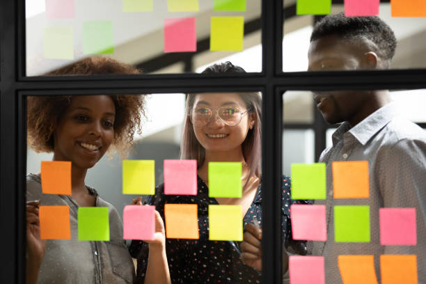 istock Happy smiling diverse colleagues working with sticky papers together 1263482043