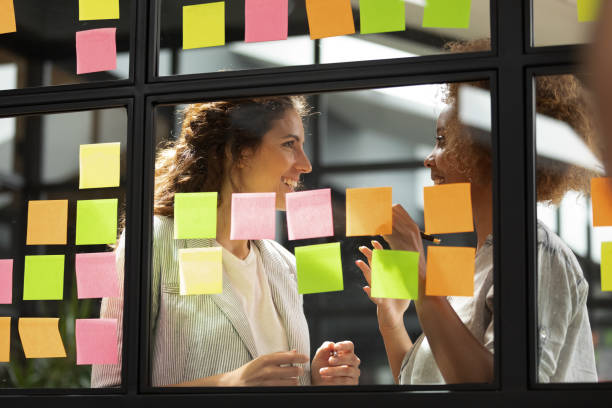 istock Happy diverse colleagues sharing ideas, working with sticky papers 1263482049
