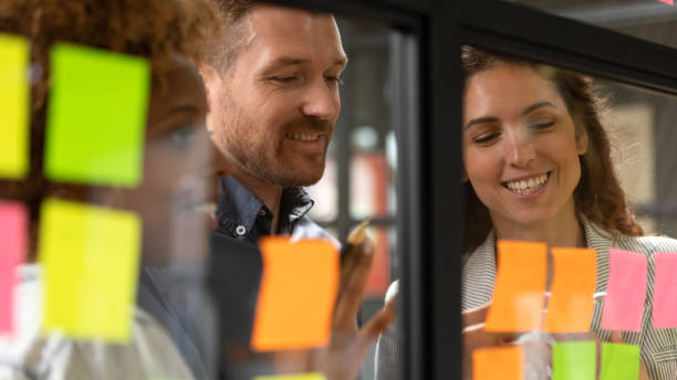 istock Creative diverse employees team writing ideas on sticky papers 1263482058