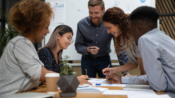 istock Happy diverse employees working with legal documents at meeting 1263482069