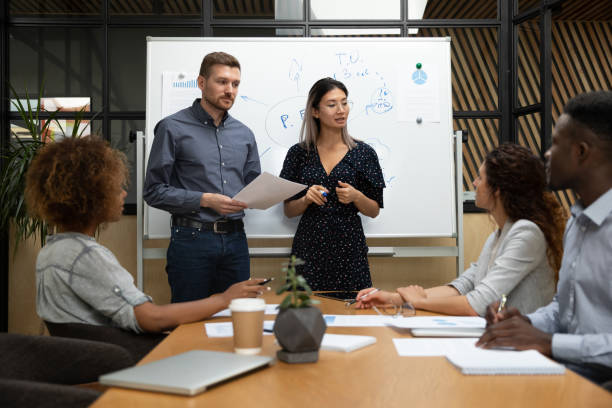 istock Diverse business coaches answering employees questions at briefing 1263482580