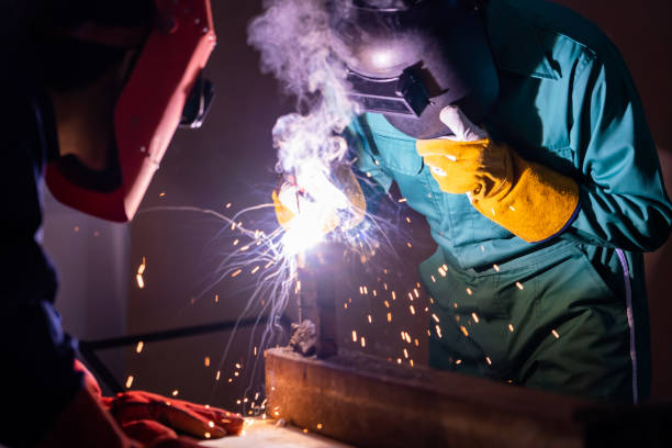 istock Metal welding steel works using electric arc welding machine 1263483721