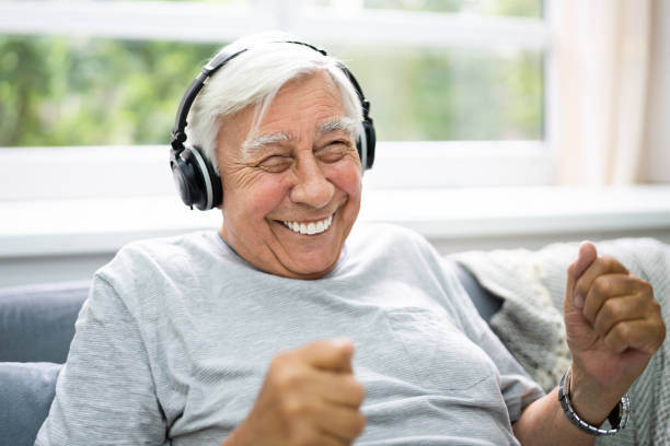 istock Smiling Older Senior Listening Music 1263483849