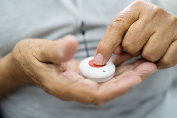 istock Close-up Of Senior Man Pressing Alarm Button 1263483906