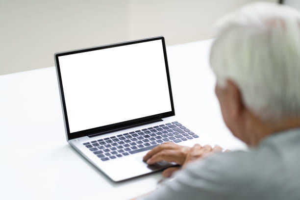 istock Close-up Of Senior Man Using Laptop Showing Blank Screen 1263484047