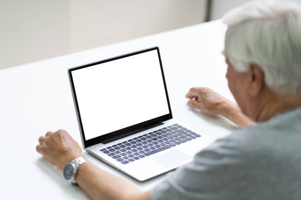 istock Close-up Of Senior Man Using Laptop Showing Blank Screen 1263484075