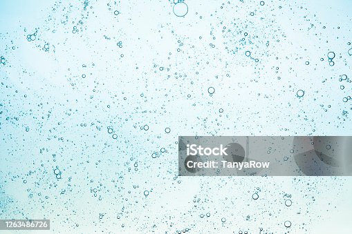 istock Blue green grey turquoise clear transparent water liquid cosmetic toner gel cooling tonic lotion lubricant gray multi-colored background 1263486726