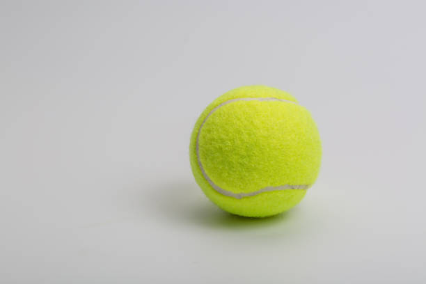 istock Green tennis ball and worker on white background 1263486781