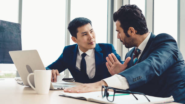 istock Two business people talk project strategy at office 1263488098