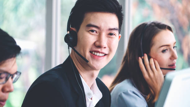istock Business people wearing headset working in office 1263489059