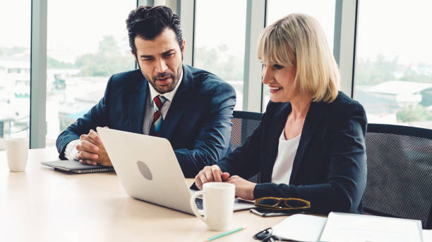 istock Two business people talk project strategy at office 1263489773