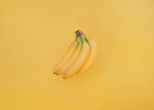 istock Yellow bananas on yellow background 1263489862