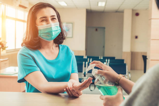 istock Receptionist and guest wearing face mask at front desk . 1263494891