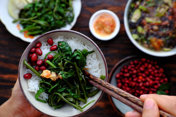 people have lunch, hand hold rice bowl with vietnamese vegan food background - indochina soup flag national flag imagens e fotografias de stock