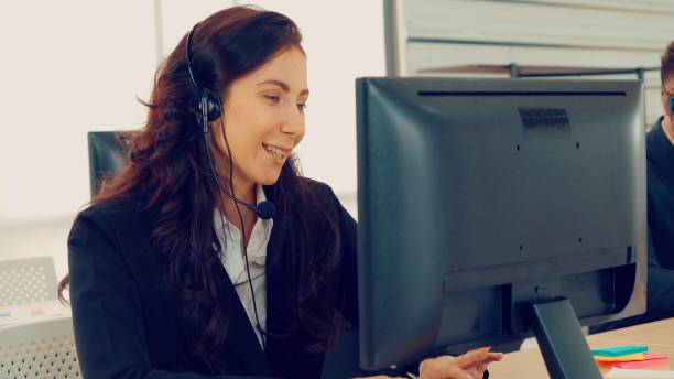 istock Business people wearing headset working in office 1263504052