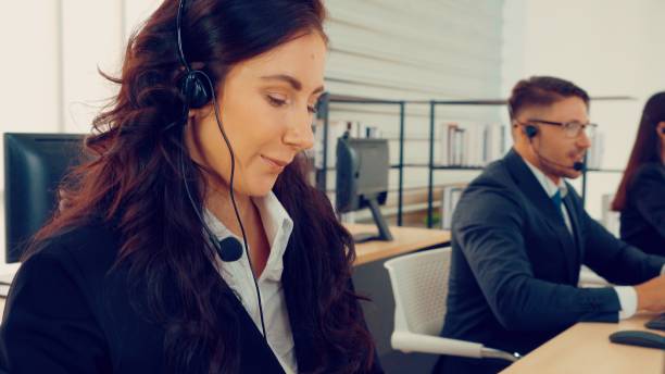 istock Business people wearing headset working in office 1263507753