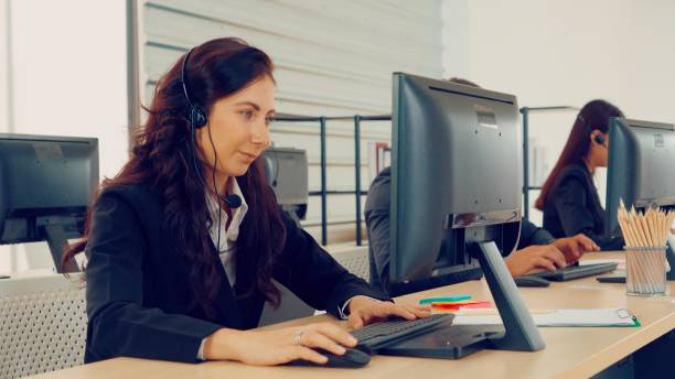 istock Business people wearing headset working in office 1263509873