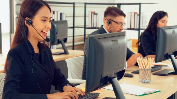 istock Business people wearing headset working in office 1263512593