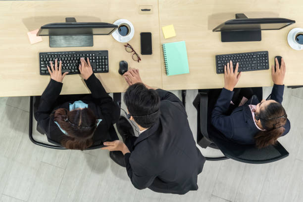 istock Business people wearing headset from top view in office working with computer 1263514479