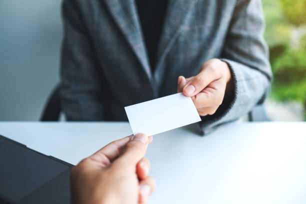 istock Two businessman holding and exchanging empty business card 1263517190