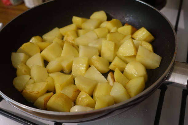 istock Portioned potatoes being fried in a pan 1263517303