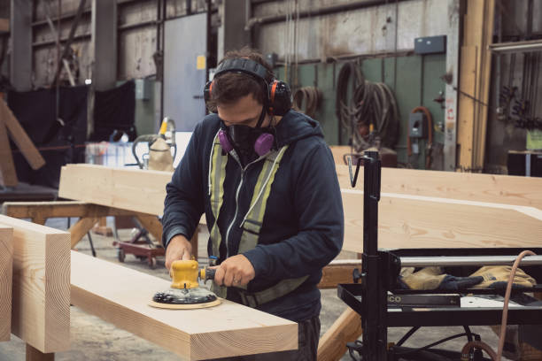 istock Factory worker wearing protective face mask sanding wood. 1263517952