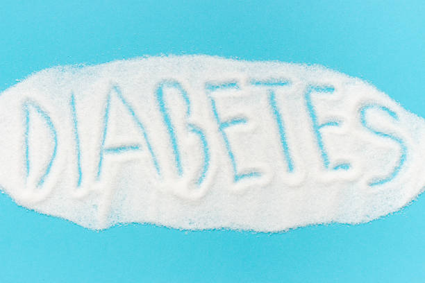 Word diabetes laid out from sugar isolated on blue background