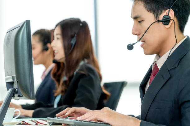 istock Business people wearing headset working in office 1263521166