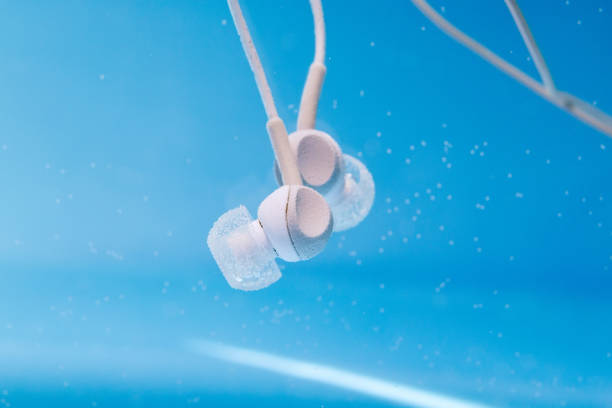 headphones for music underwater in water close up selective focus headphones for music in the water. musicfan enjoy the music, the concept. Deep dive. waterproof equipment headphones plugged in photos stock pictures, royalty-free photos & images