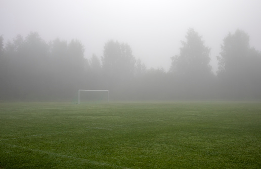empty sports field in fog