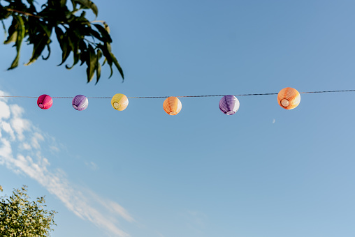 Colorful Light Lampions Hanging over Blue Sky