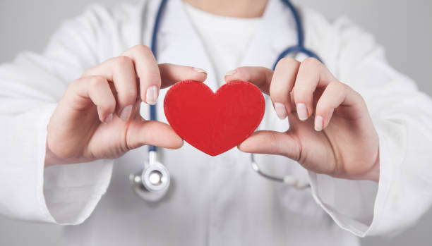 istock Doctor with stethoscope holding red heart. 1263529410