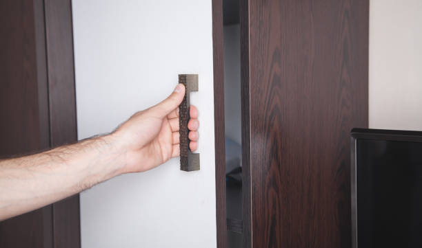istock Hand opening wardrobe doors in home. 1263529429