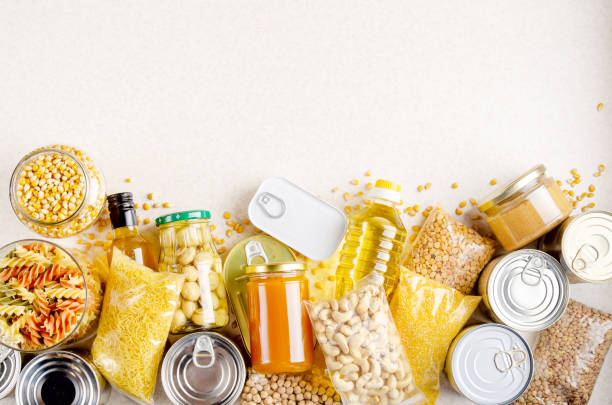 istock Flat lay view at kitchen table full with non-perishable foods. Spase for text 1263529495