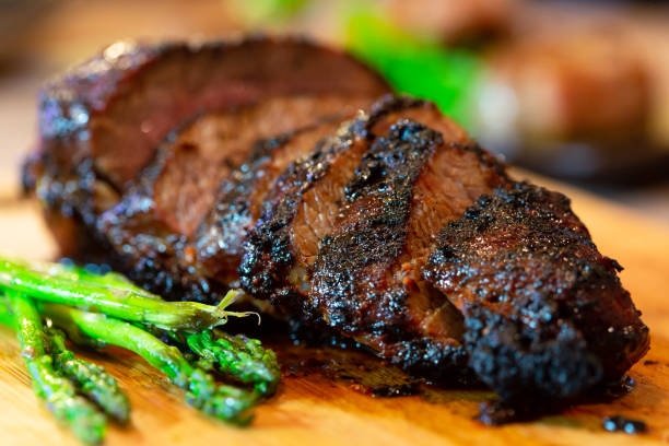 Grilled Beef Tri tip on a cutting board Grilled Tri Tip with asparagus brisket photos stock pictures, royalty-free photos & images