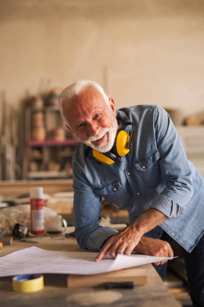 istock Portrait of a nice elderly carpenter smiling 1263533345