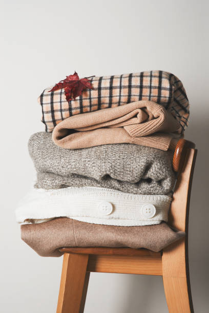 istock Autumn cozy clothes stack close up on chair 1263534898
