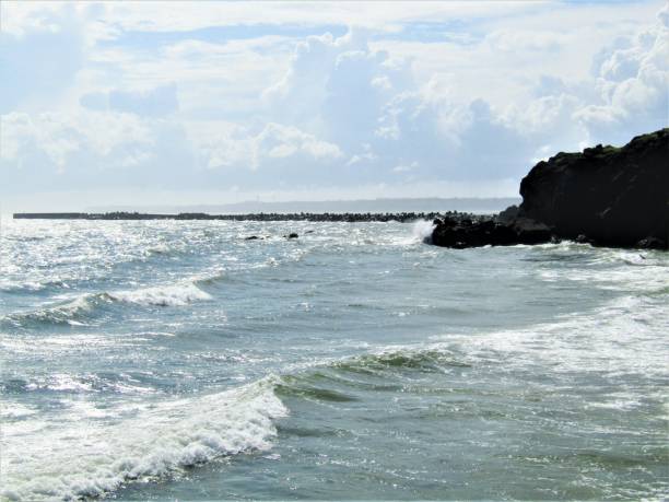 istock Japan. July. Nice sunny day. Waves hitting coastal rocks 1263535852
